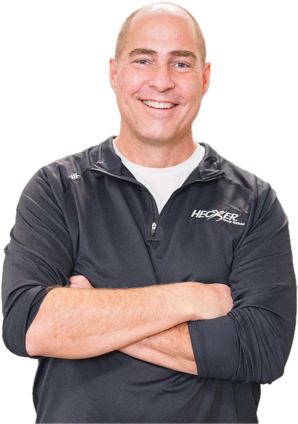 Dr. Tom Hecker, DPM, arms crossed, in his clinic pullover
